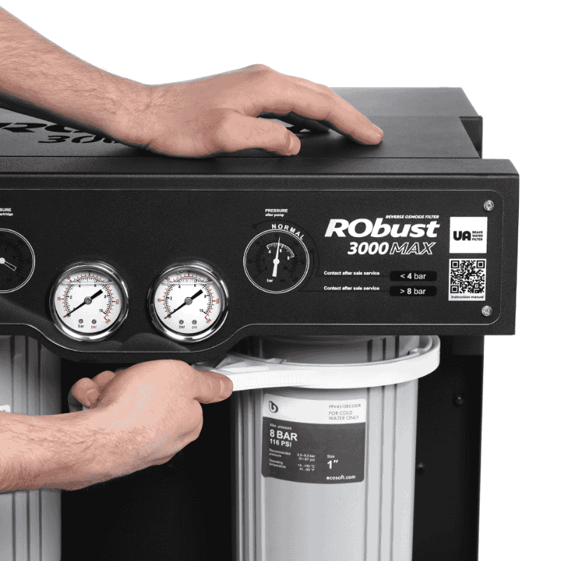 BWT RObust 3000MAX reverse osmosis water filter system being serviced with hand adjusting the filter, showing maintenance process and filtration components.